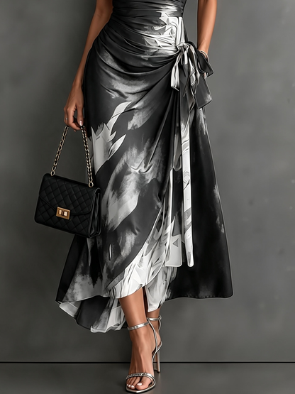 Vestido midi cruzado con estampado abstracto blanco, escote en V, manga corta, cintura anudada y bajo asimétrico con volante