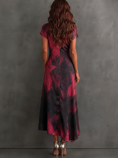 Vestido midi cruzado con estampado abstracto rojo y negro, escote en V, manga corta, cintura anudada y bajo asimétrico con volante