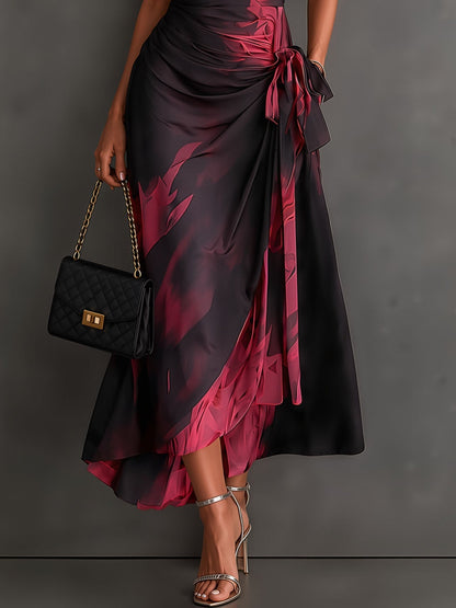 Vestido midi cruzado con estampado abstracto rojo y negro, escote en V, manga corta, cintura anudada y bajo asimétrico con volante